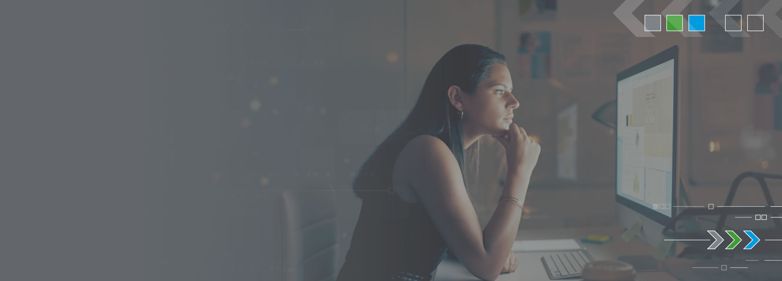 woman in black shirt staring at computer screen