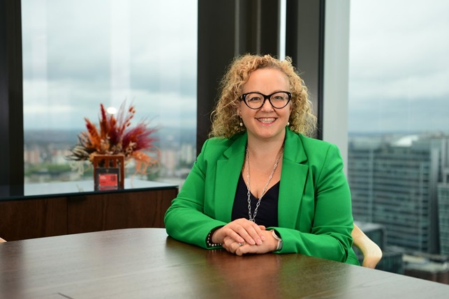 blonde woman in green suit
